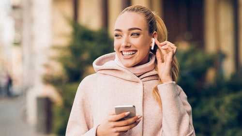 Mujer escuchando música con sus Airpods  