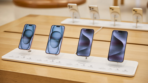 Los diferentes modelos de iPhone 15, 15 Plus, 15 Pro y 15 Pro Max exhibidos sobre una mesa en una tienda Apple